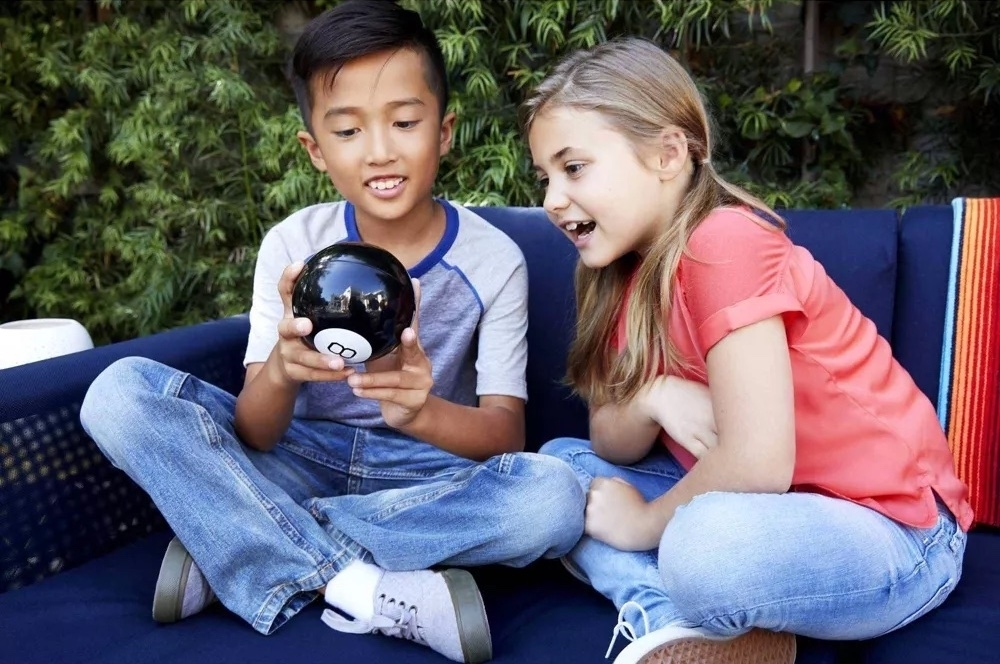two children play with the magic 8 ball