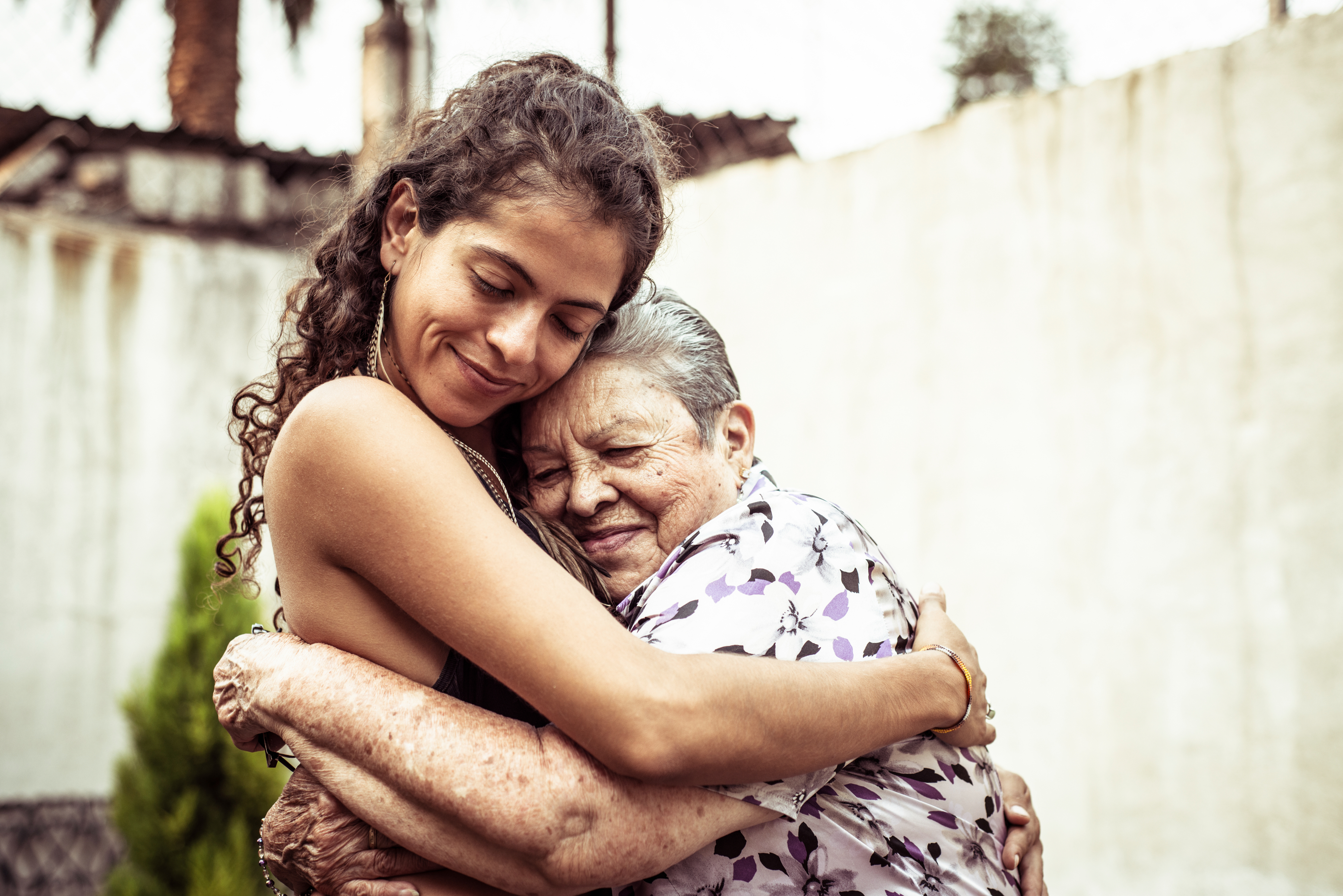 A young woman and her grandma hugging