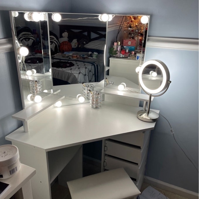 a white vanity in a bedroom