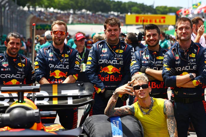 MGK posing with race car drivers
