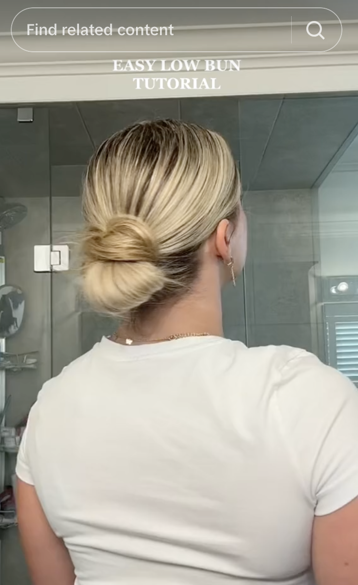 a girl with a slicked back bun