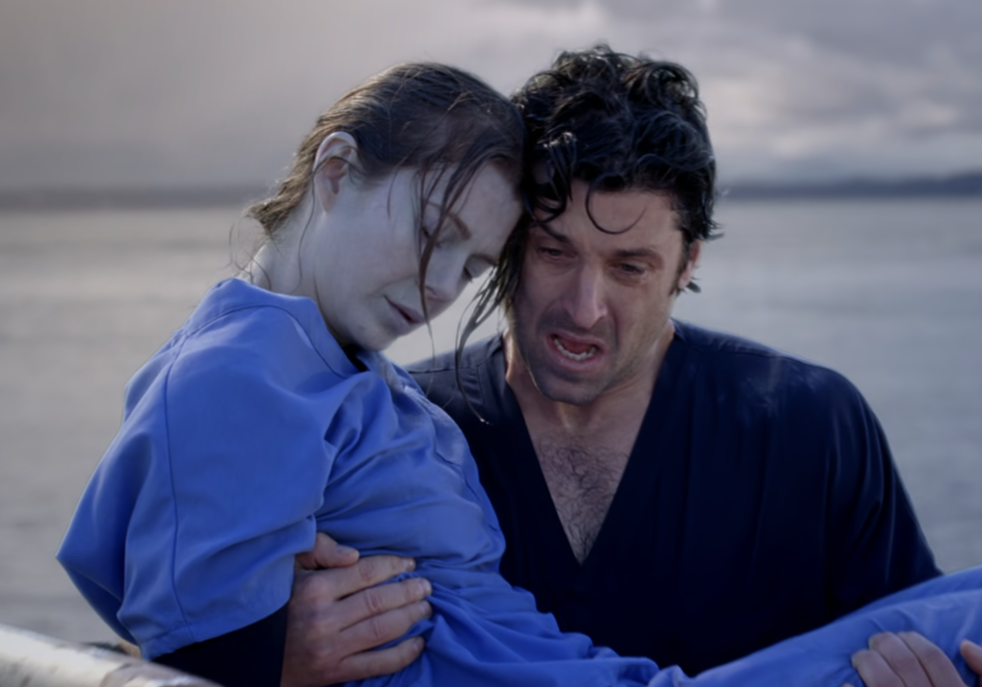 McDreamy carrying an unconscious Meredith Grey in Grey&#x27;s Anatomy with water behind them