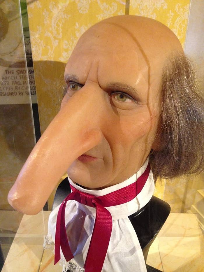 A wax sculpture with a big nose