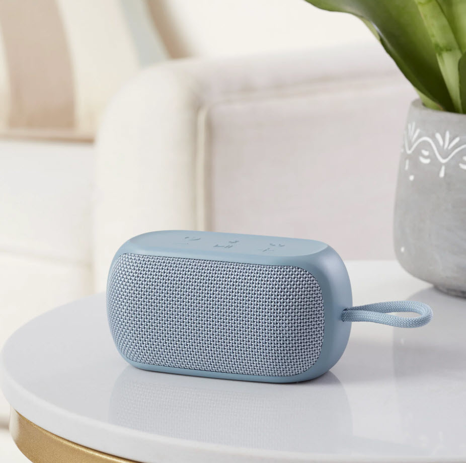 small baby blue speaker on a table