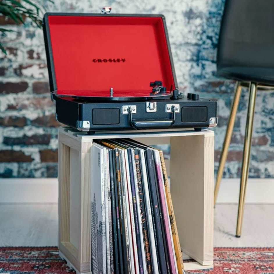 open Crosley record player on top of boxed records