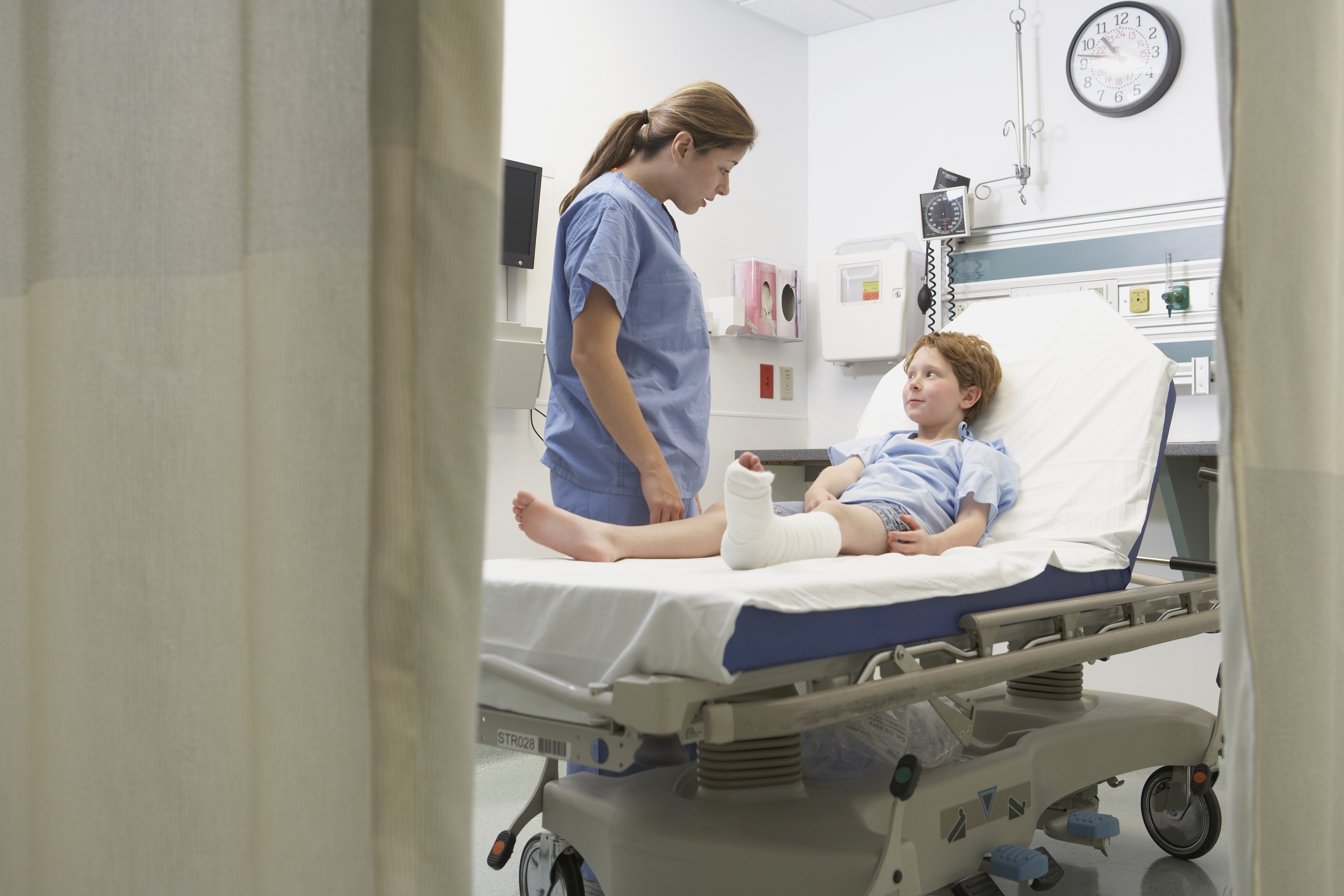 a young patient with a broken leg in a hospital bed