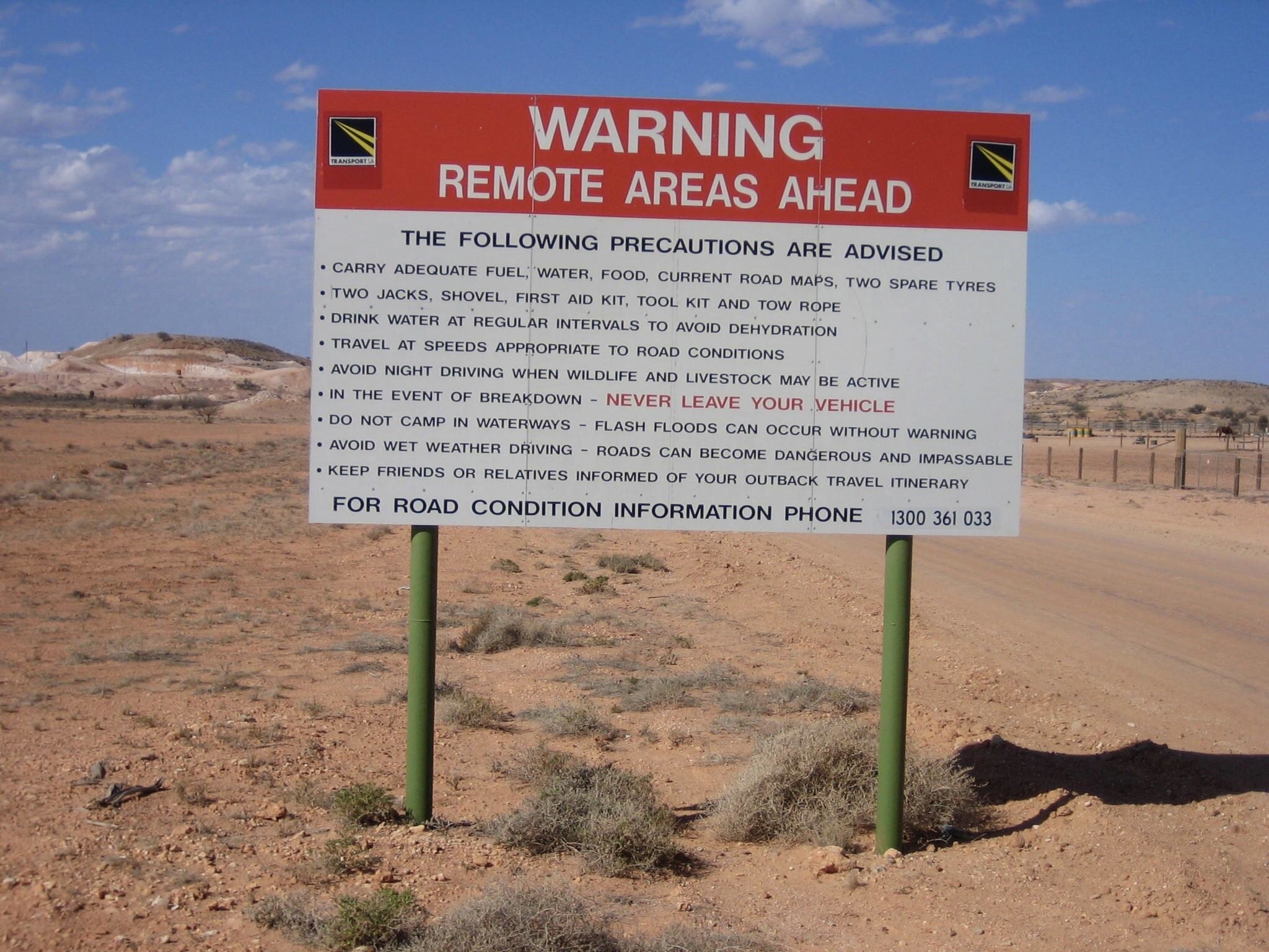 &quot;Remote Areas Ahead&quot; sign in an arid area, with warnings to &quot;carry adequate fuel, water, food, current road maps, and two spare tyres&quot; and &quot;keep friends or relatives informed of your outback travel itinerary,&quot; among others