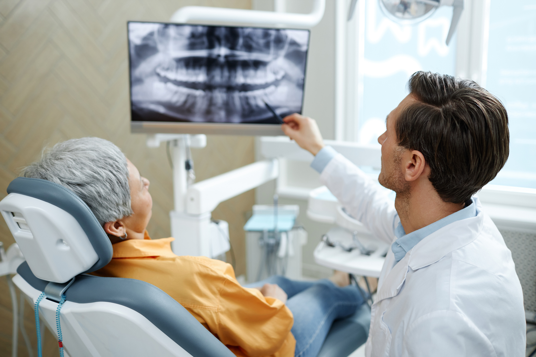 A dentist showing a scan to a patient