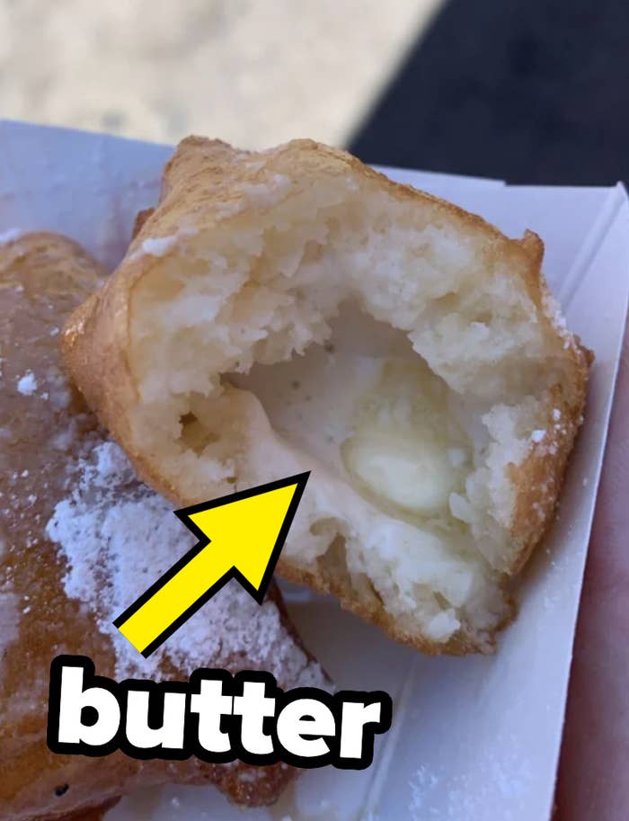 A person is showing off the fried butter they got at a state fair
