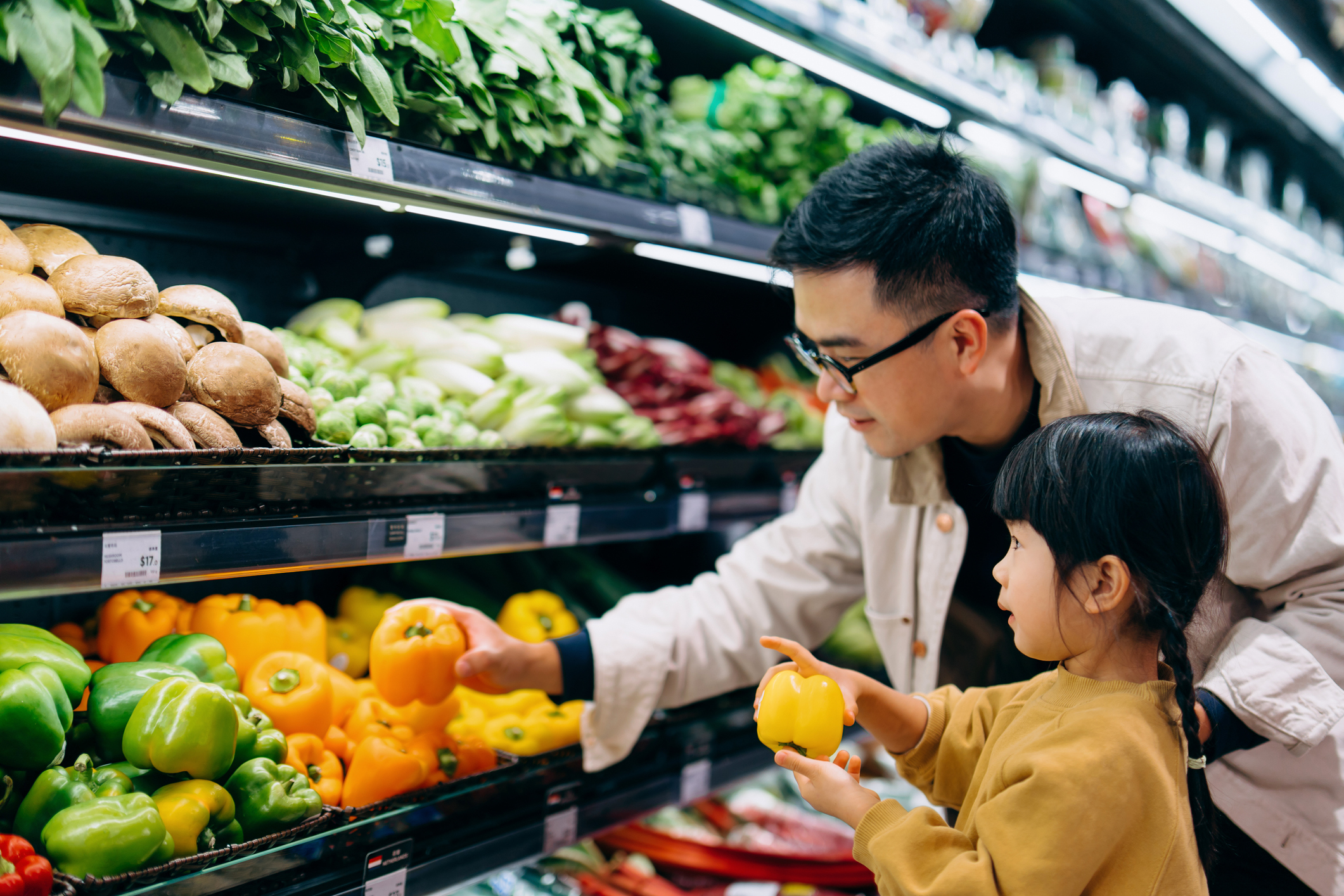 A man and his daughter shopping for groceries