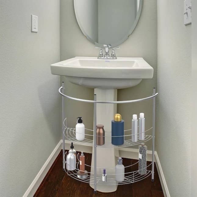silver under-sink wire organizer below bathroom vanity