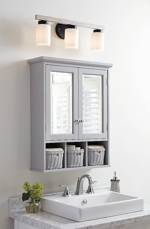 gray medicine cabinet with three matching baskets over vanity