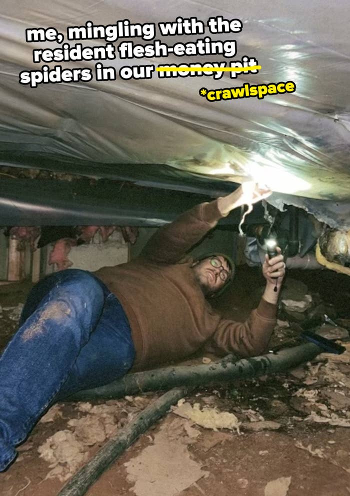 author laying on his back in a dirt crawlspace under house with text saying that he's hanging out with the resident flesh-eating spiders
