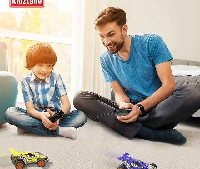 Child and adult play with cars