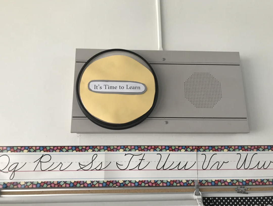 The clock is covered with a piece of paper that says "it's time to learn"