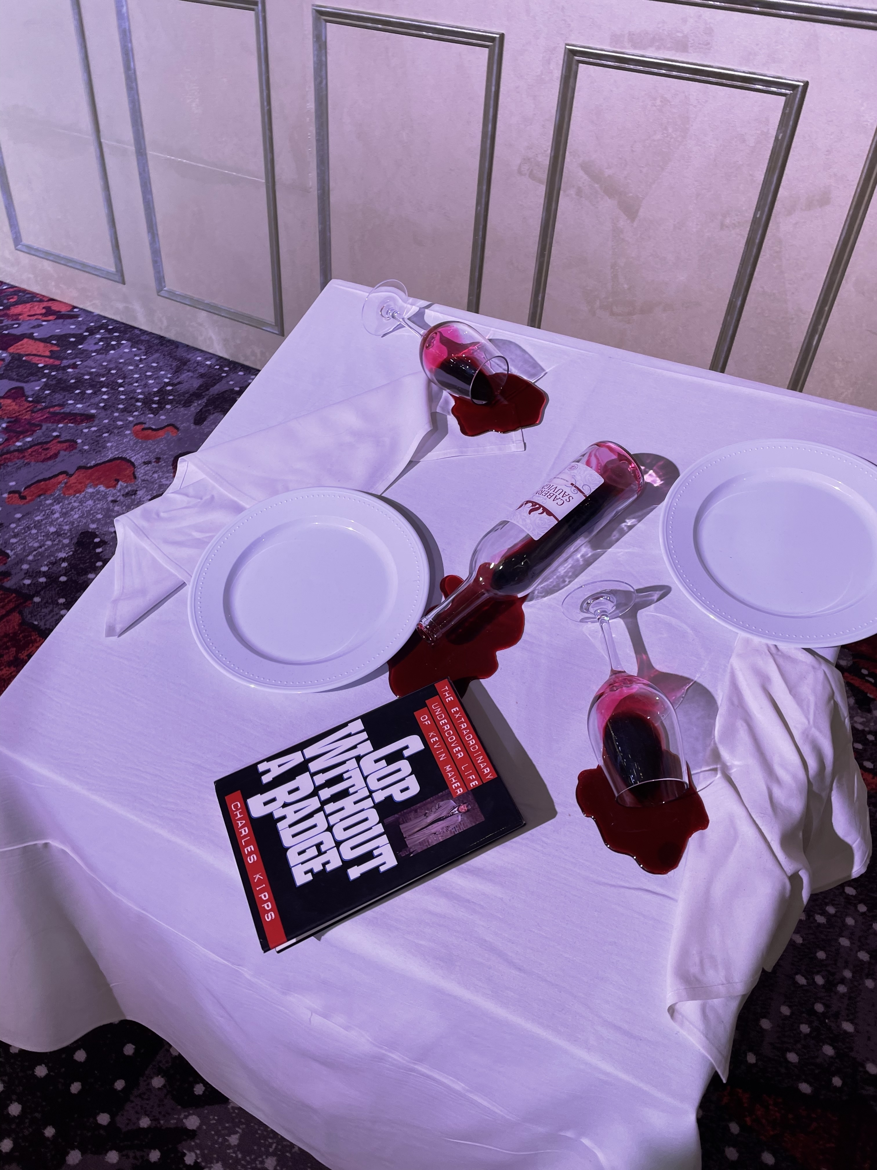 A white table cloth on a table displaying Danielle&#x27;s &quot;A cop without a badge&quot; book