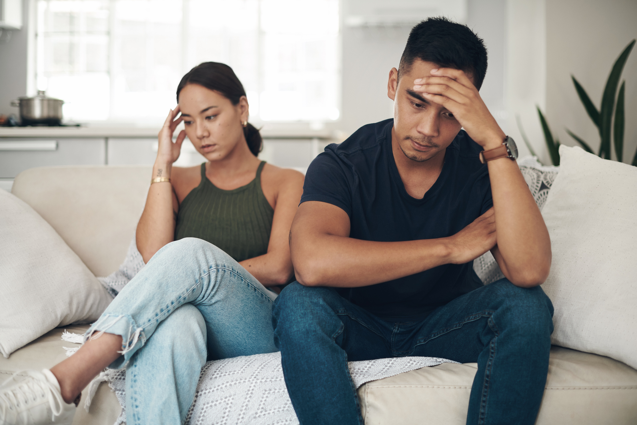 frustrated couple sitting on the couch