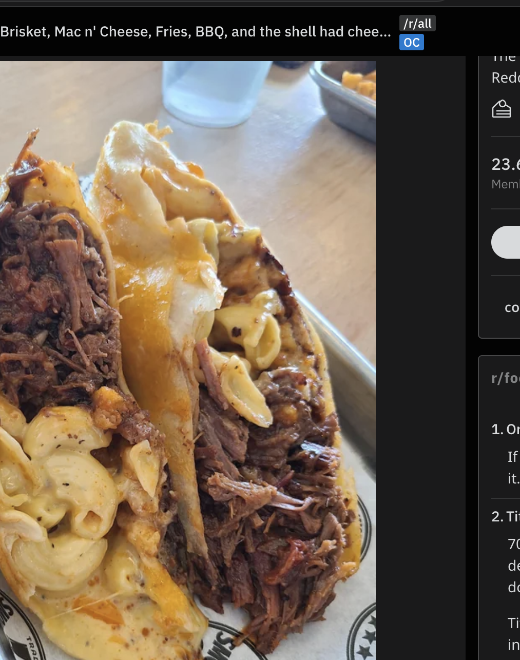 A taco shell is filled with mac and cheese and brisket
