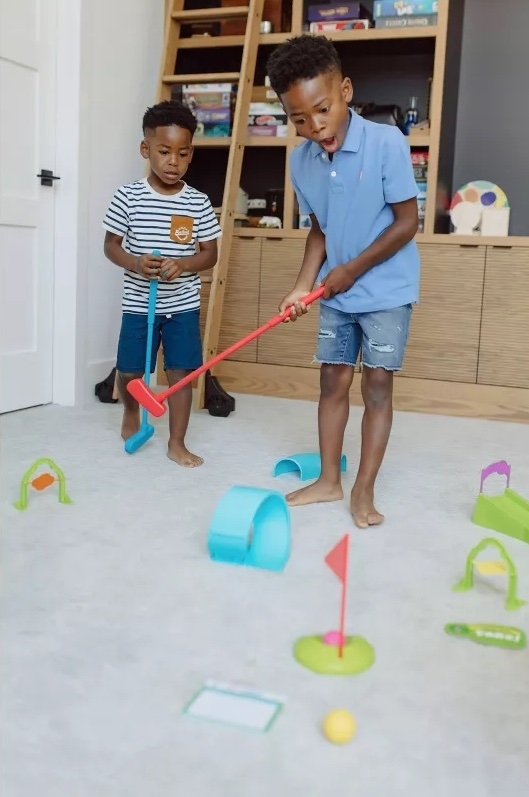two kids play with the set