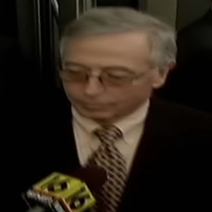 a man being interviewed by reporters