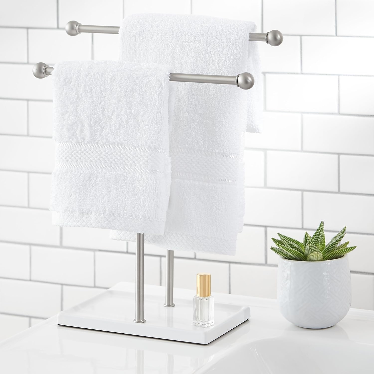 the two-tier towel holder in silver with hand towels hanging from each one