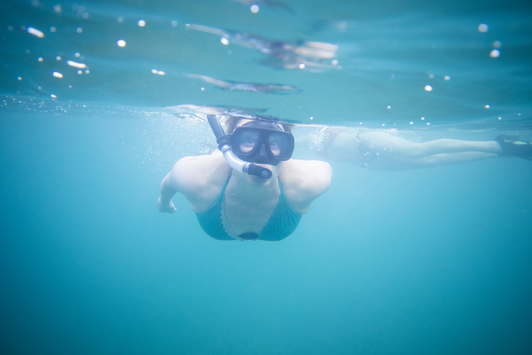 person in the water with a scuba mask