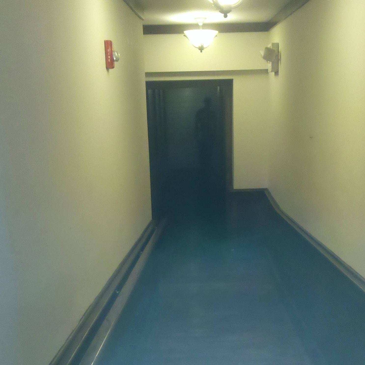 a dark figure in a hallway