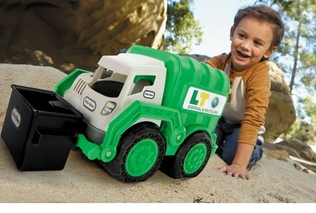 Child plays with a toy trash truck