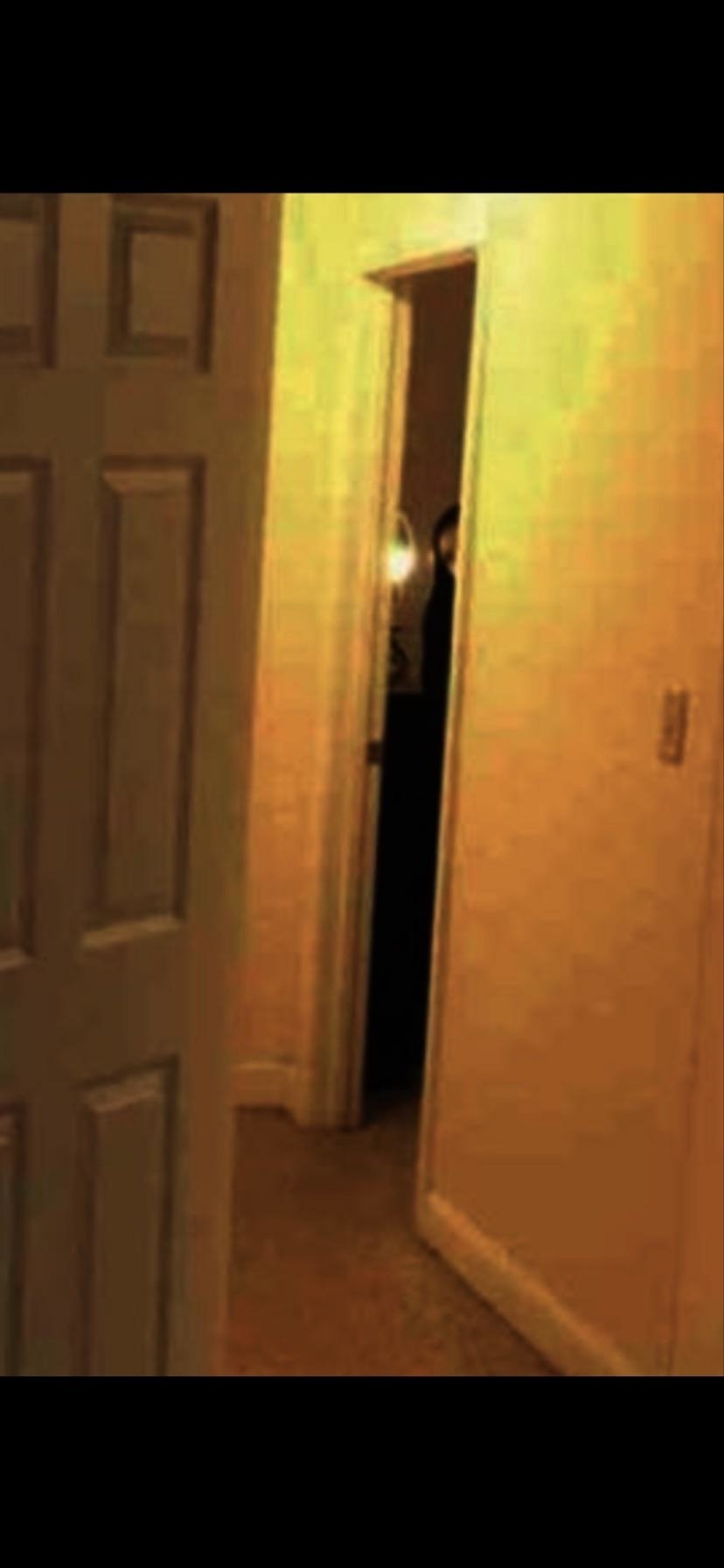 a figure in a doorway