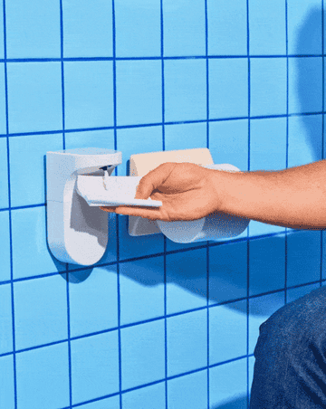 gif of model putting a wipe under dispenser and soap coming out