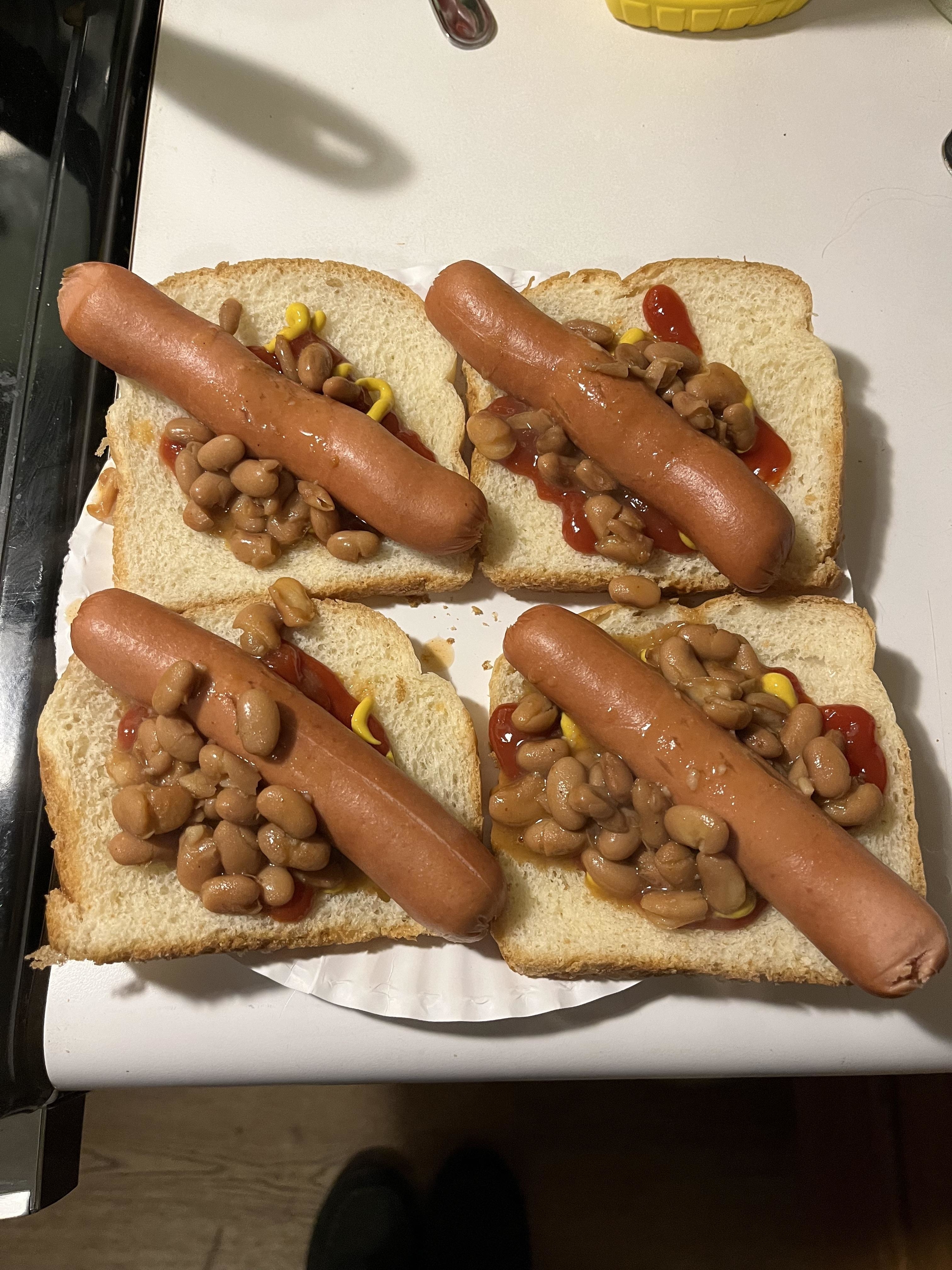 hot dogs and canned beans with ketchup and mustard on sliced white bread