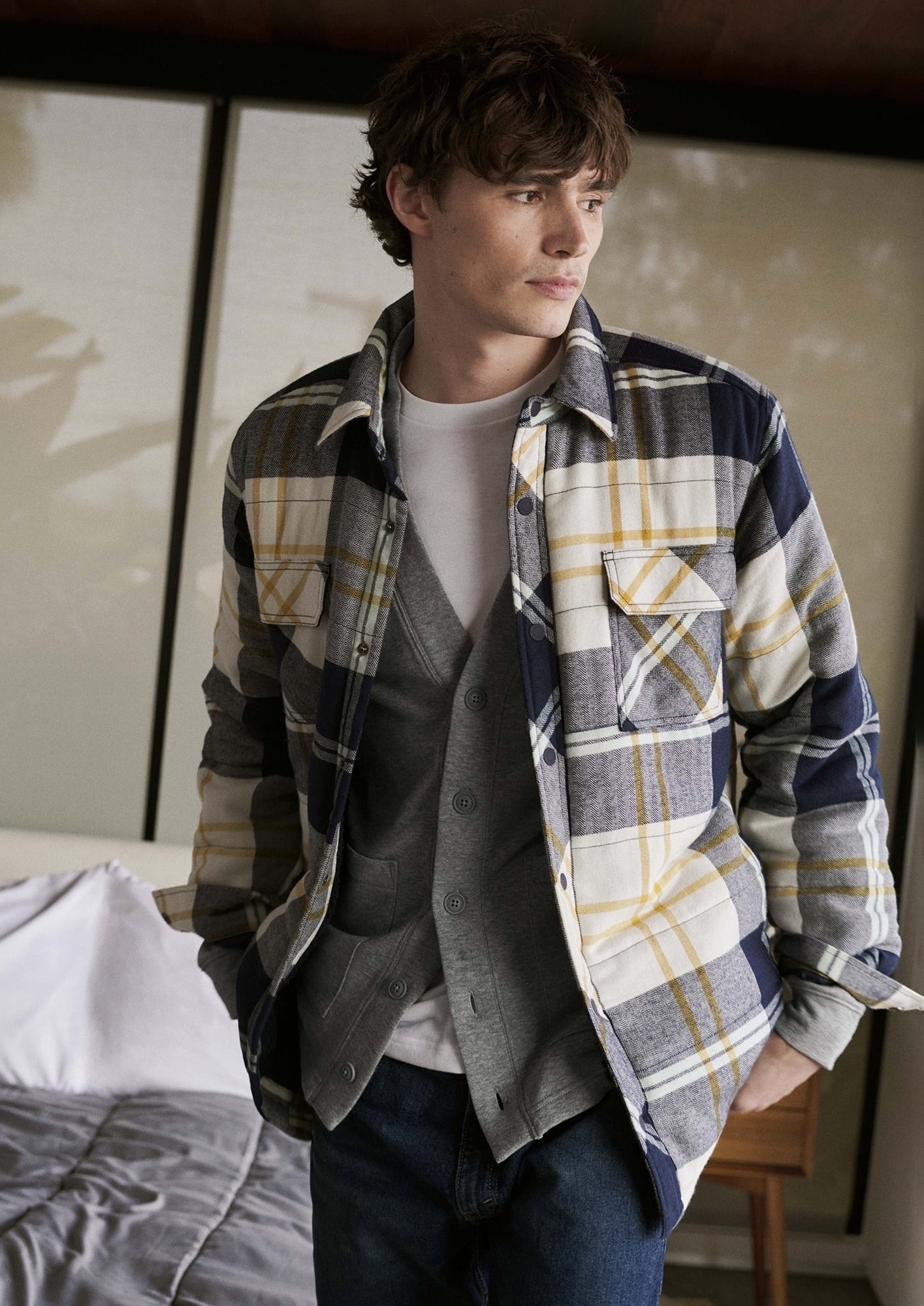 model wearing the blue and yellow plaid flannel