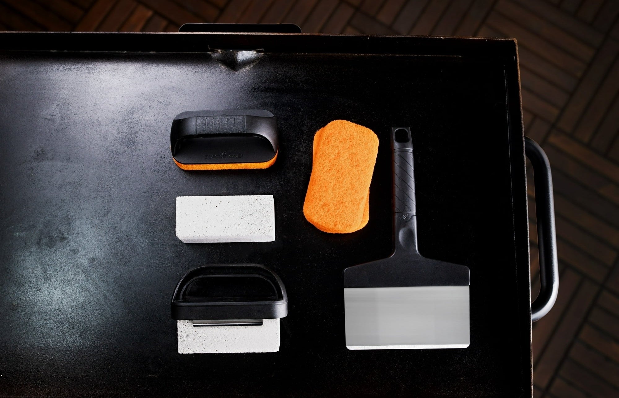 the griddle cleaning kit on a black grill