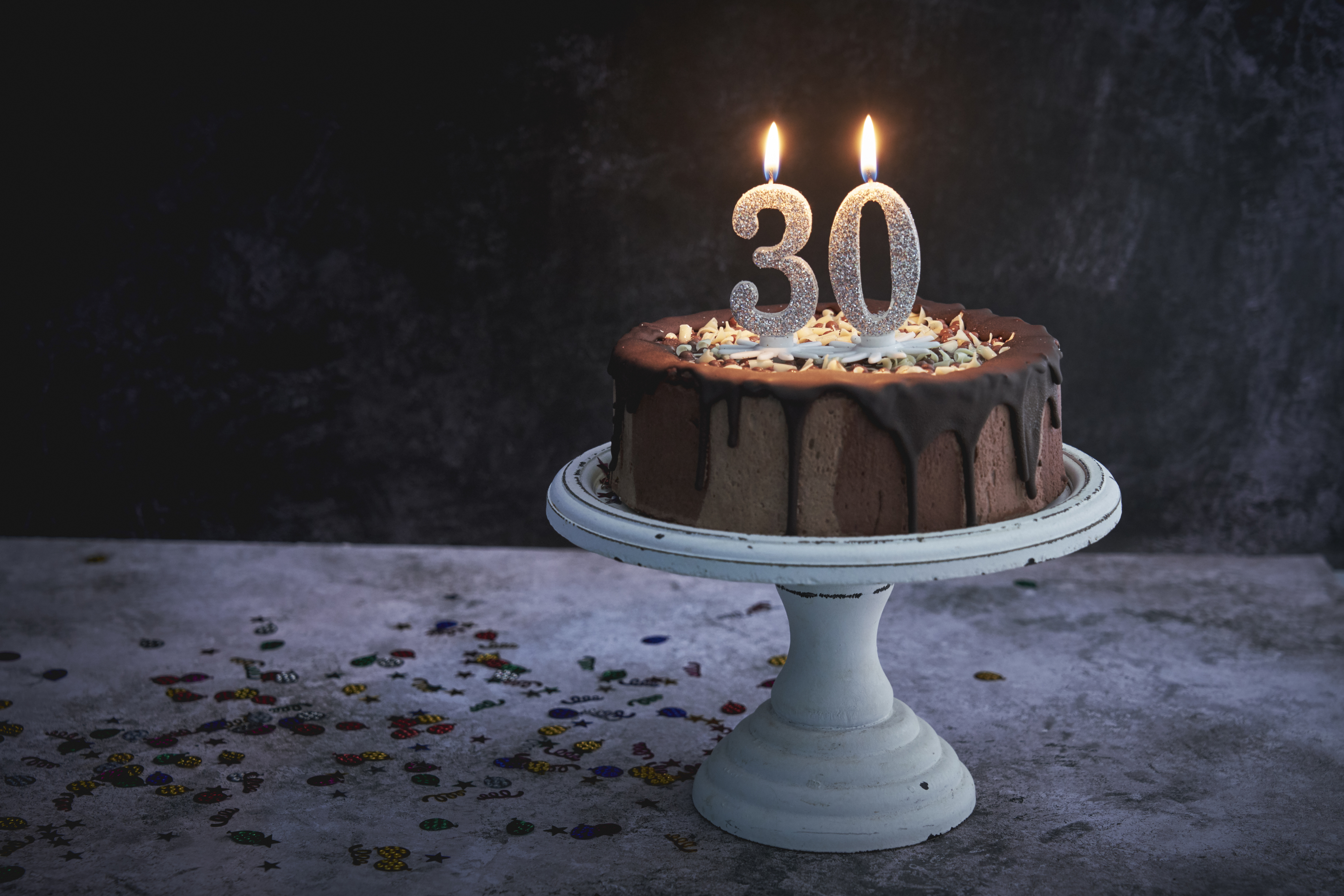 a birthday cake with candles that make the number 30