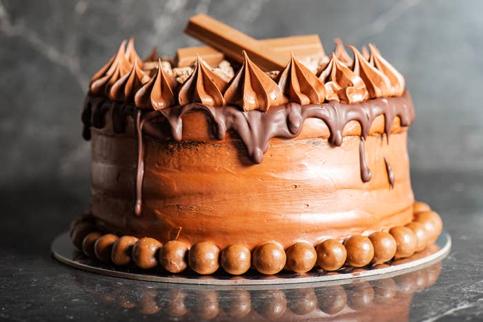 a chocolate cake with chocolate frosting and drips of chocolate ganache