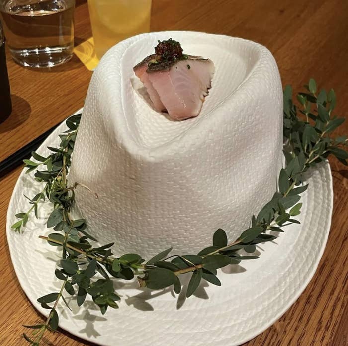 served on a straw hat with vines around it