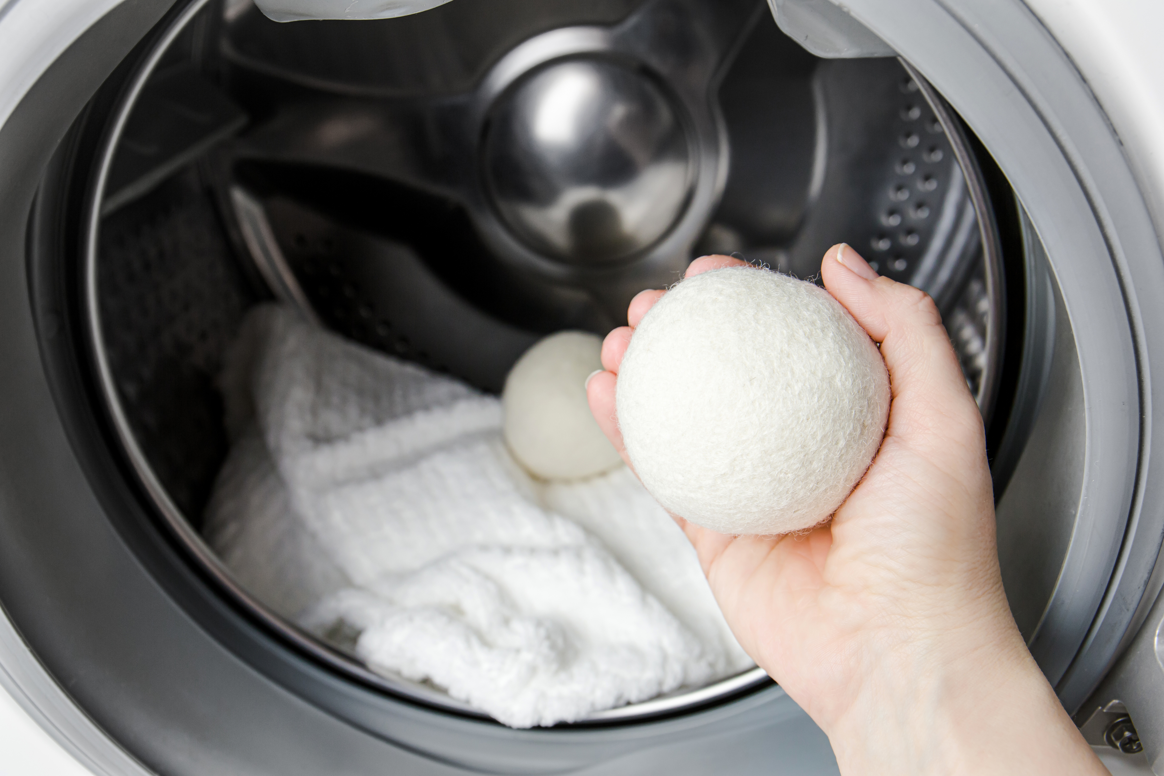 hand holding a wool dryer ball