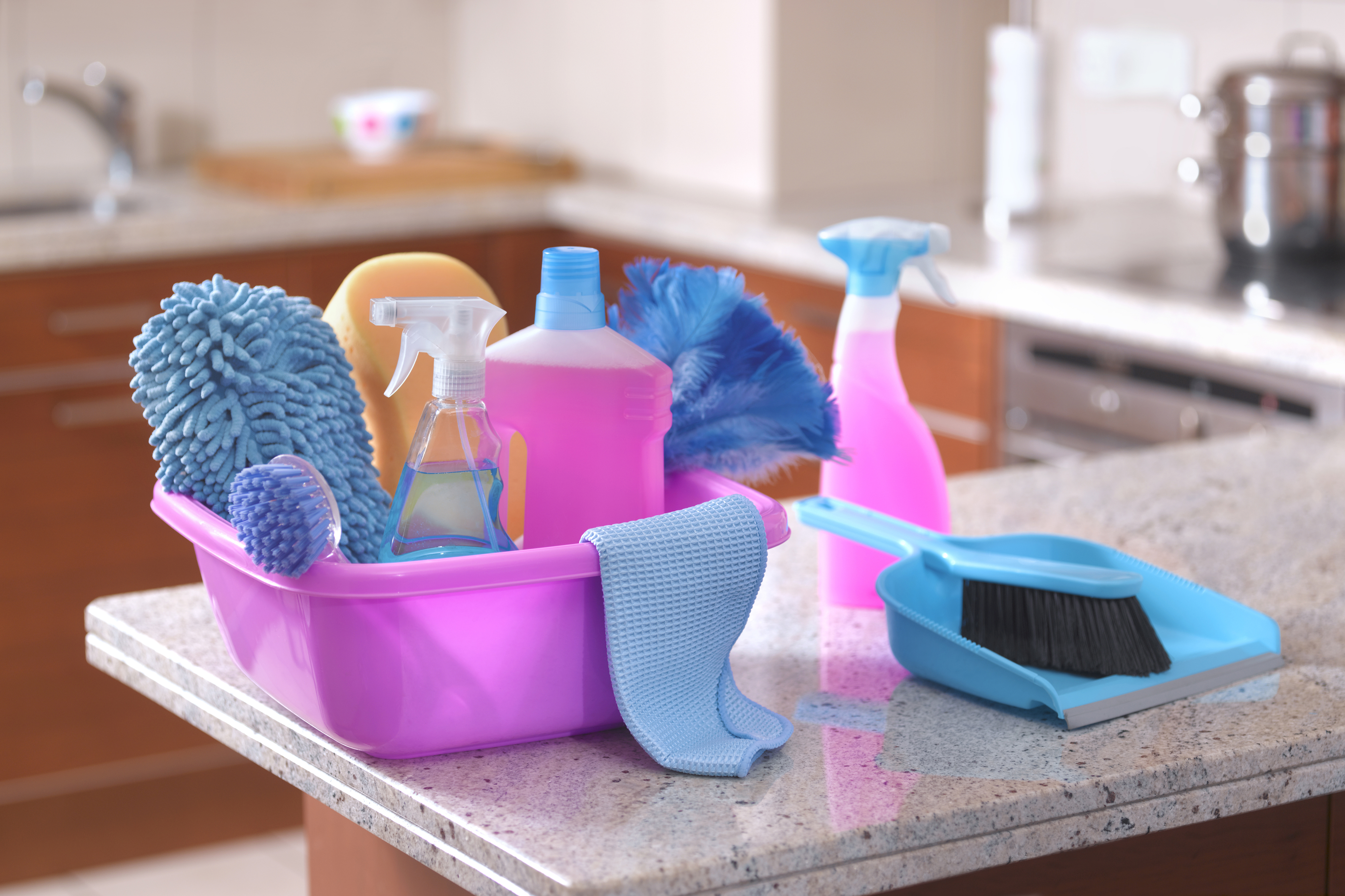 basket of cleaning products on a kitchen counter