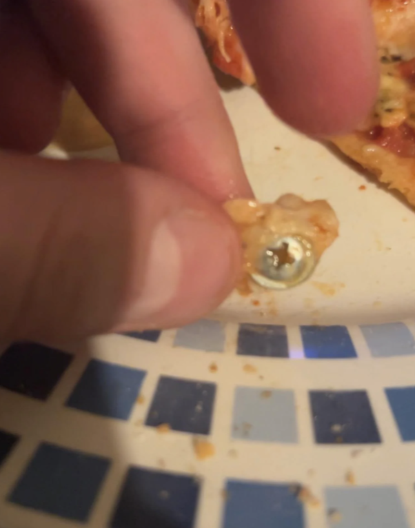 closeup of the screw found in the pizza