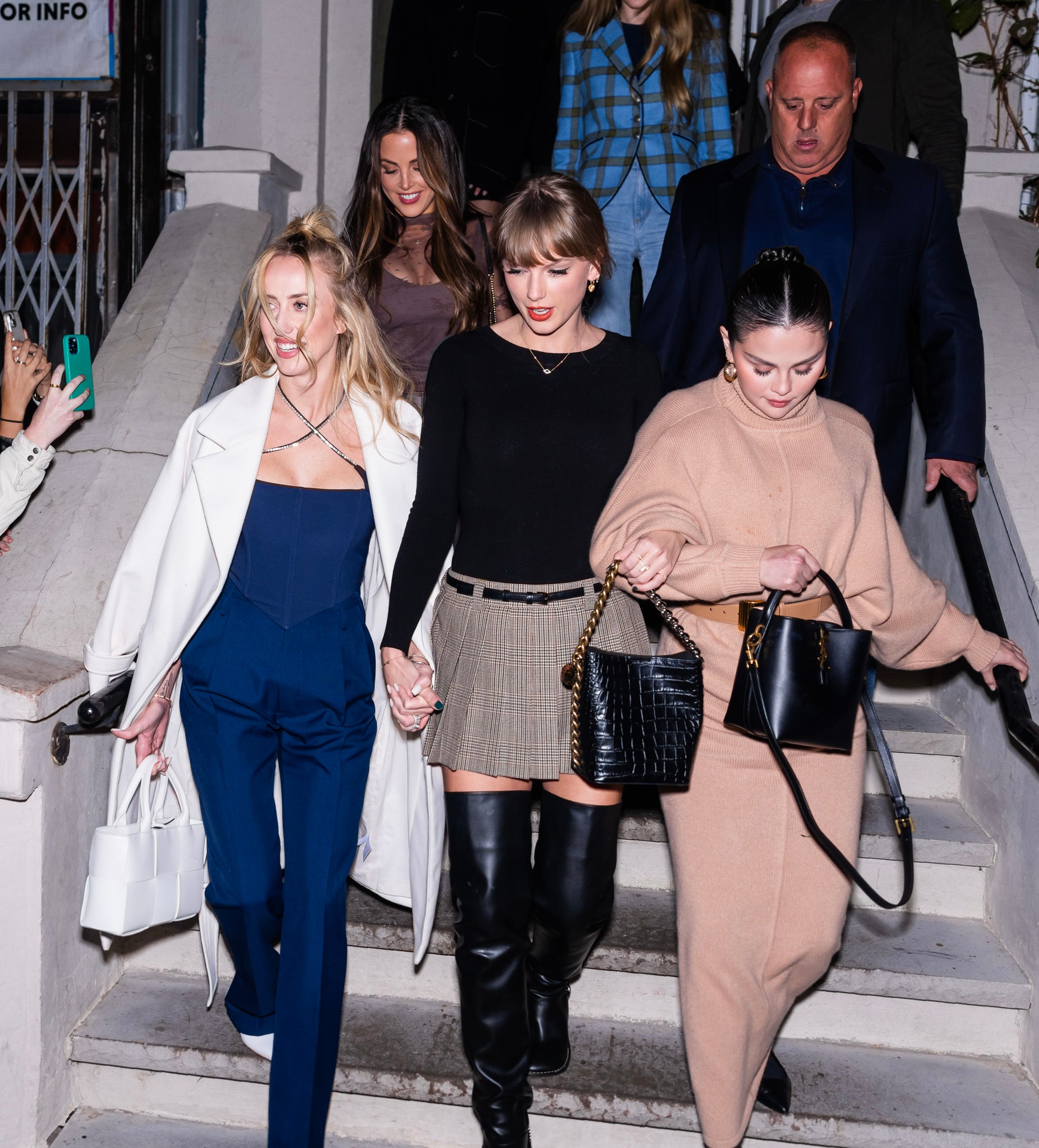 Taylor and friends exiting a building