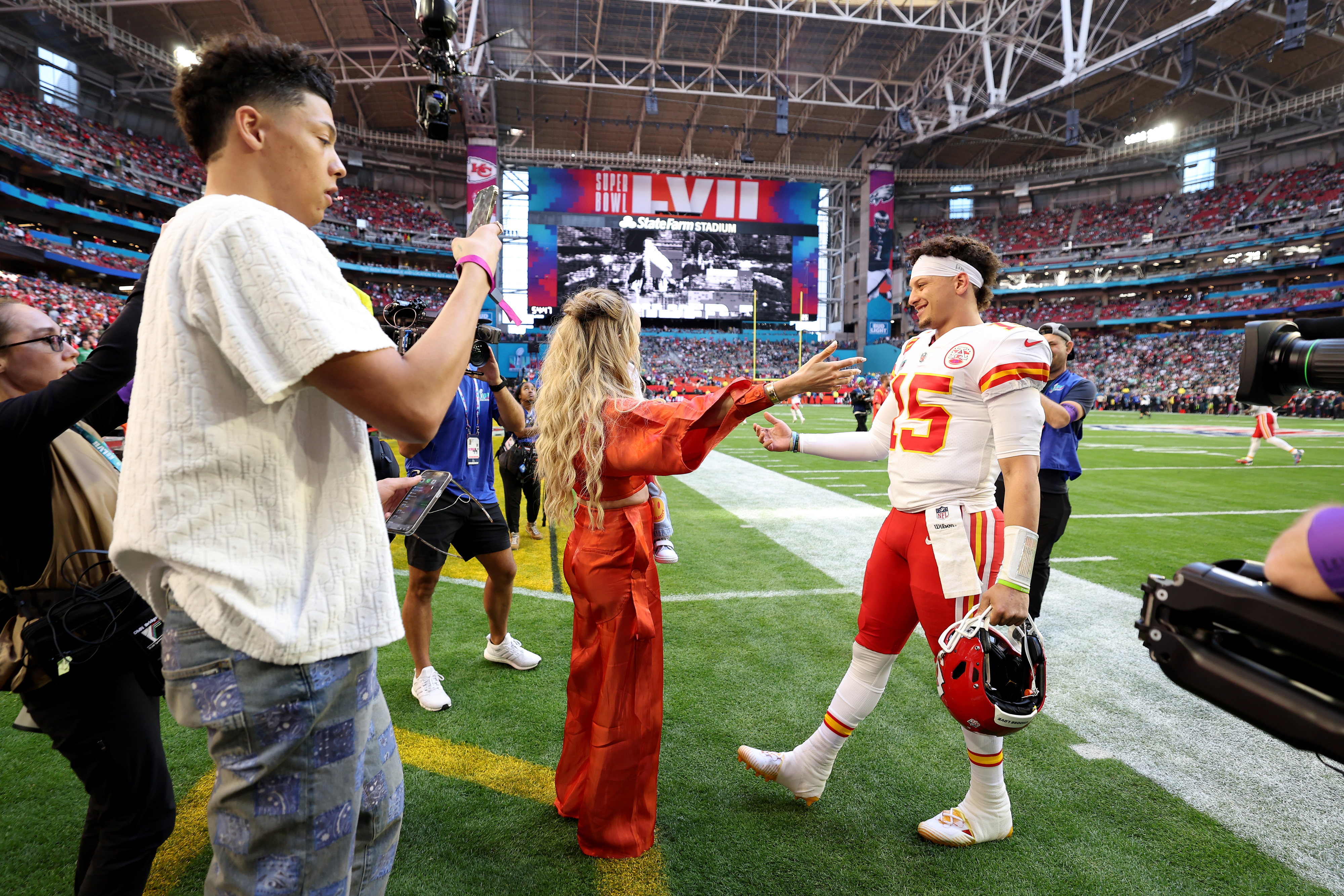 Jackson, Brittany, and Patrick Mahomes on the field