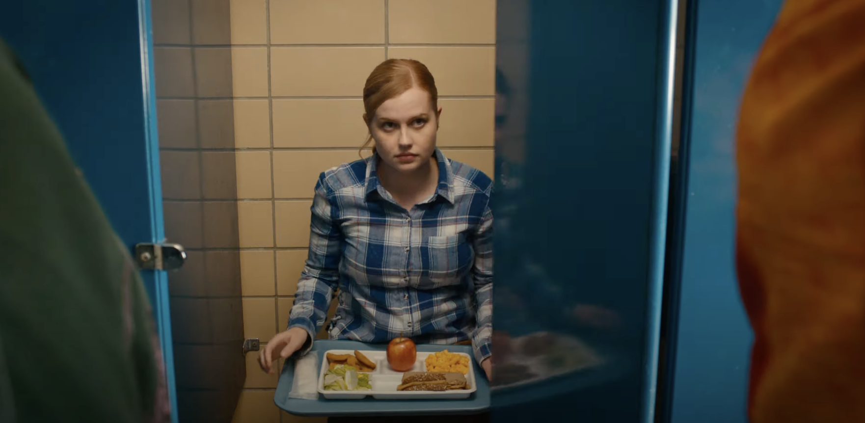 sitting in a bathroom stall eating her lunch