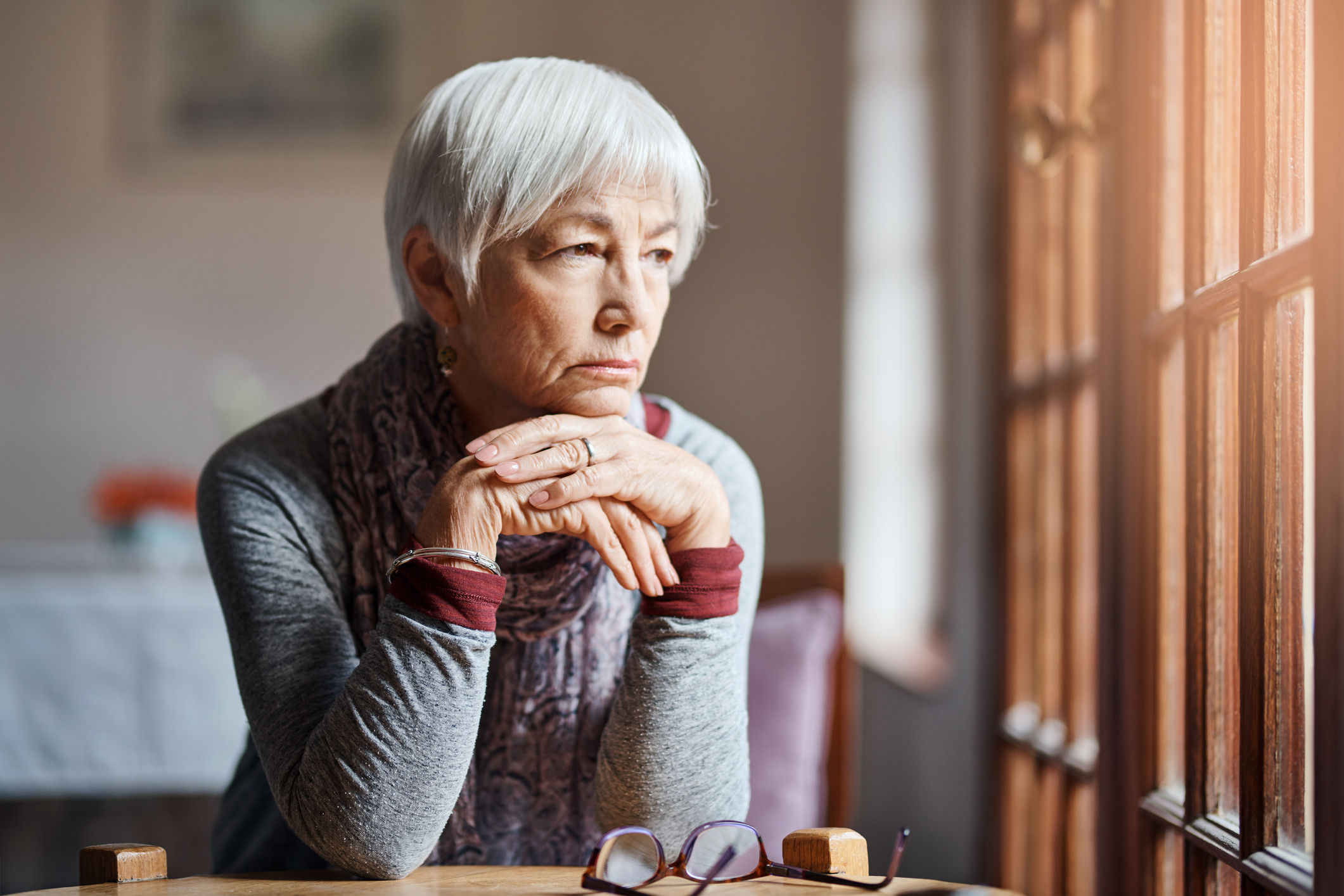 older woman looking out the window