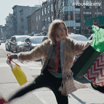 Woman dances with shopping bags