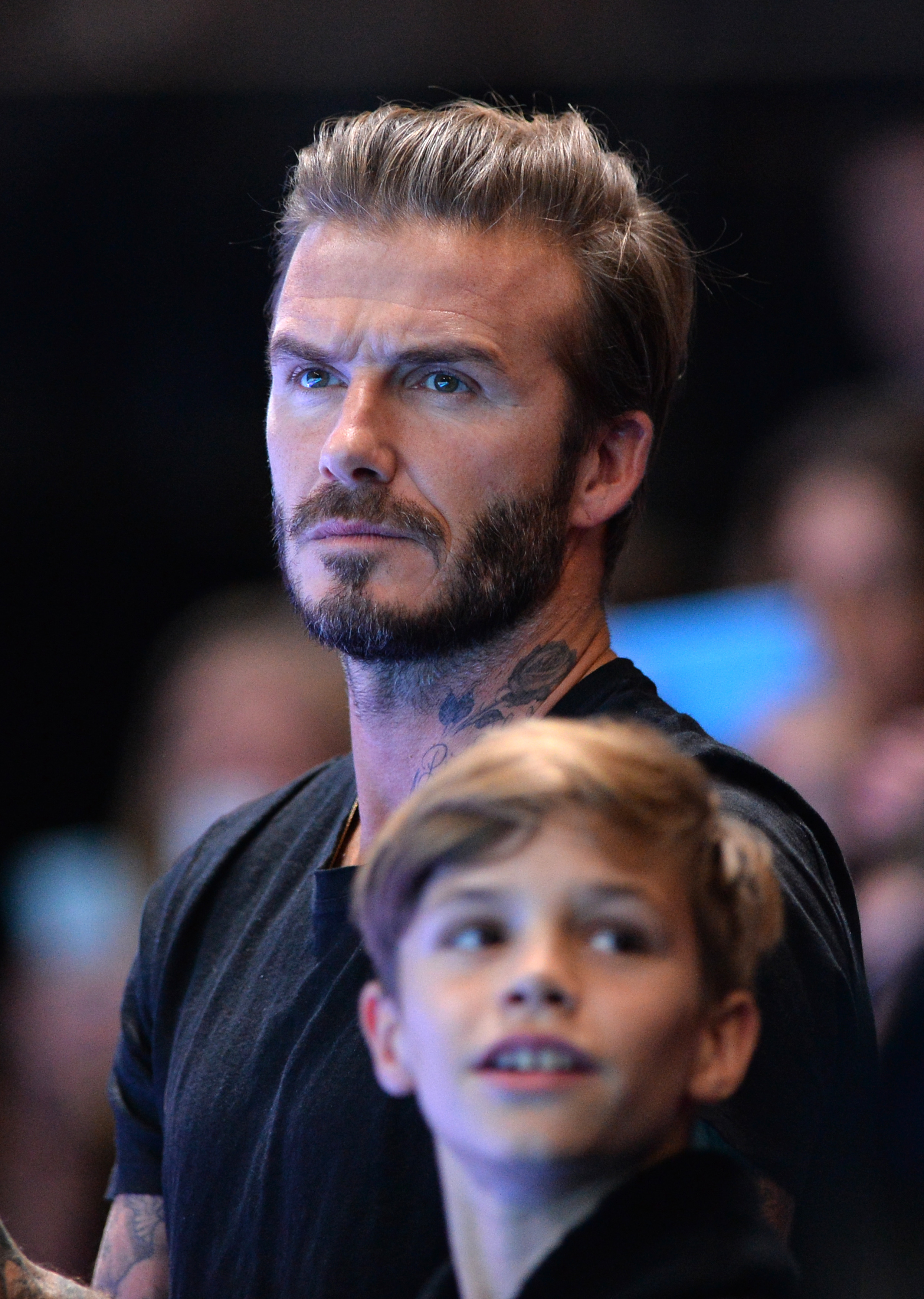 Closeup of David Beckham with his son