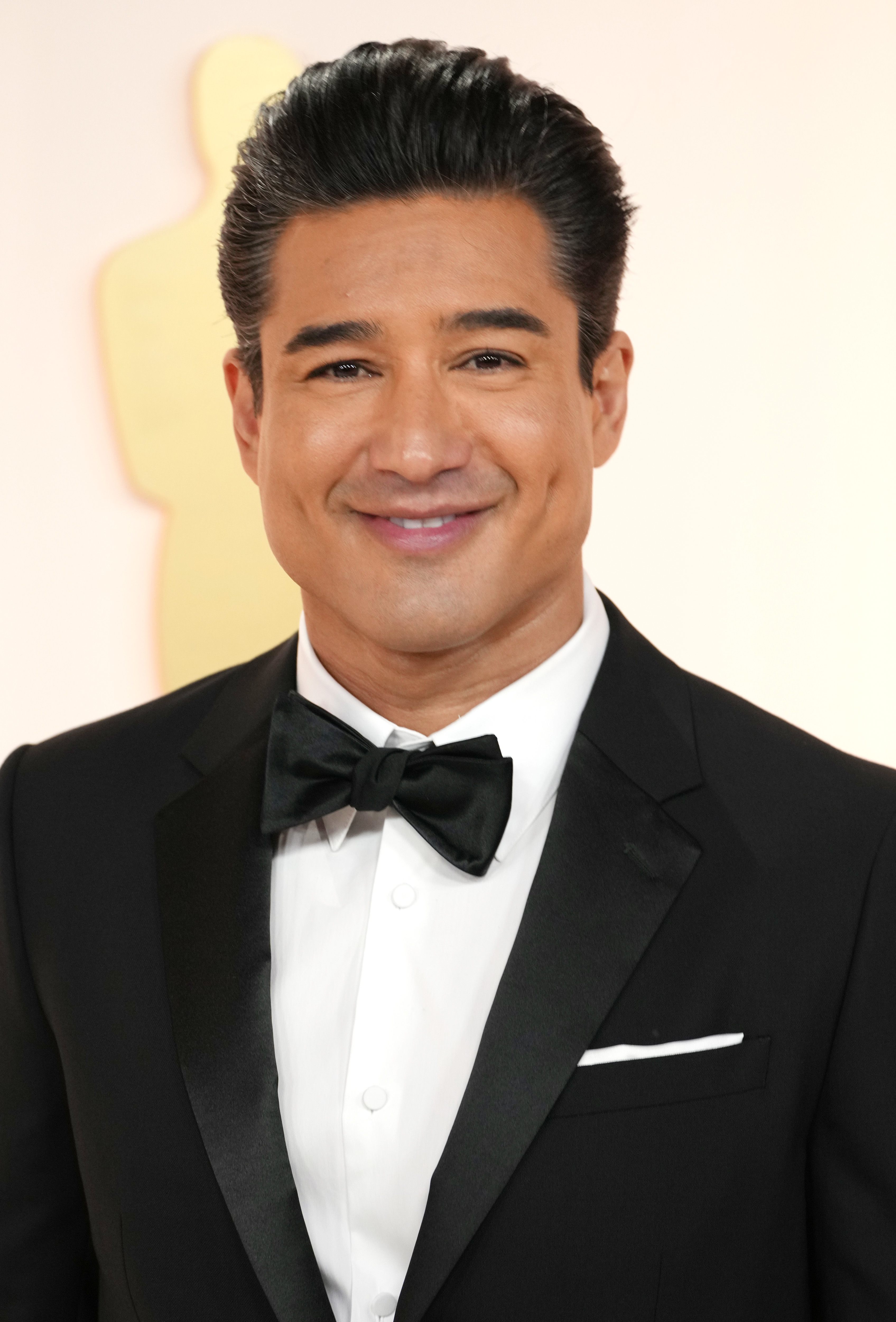 Closeup of Mario Lopez in a tux at a media event