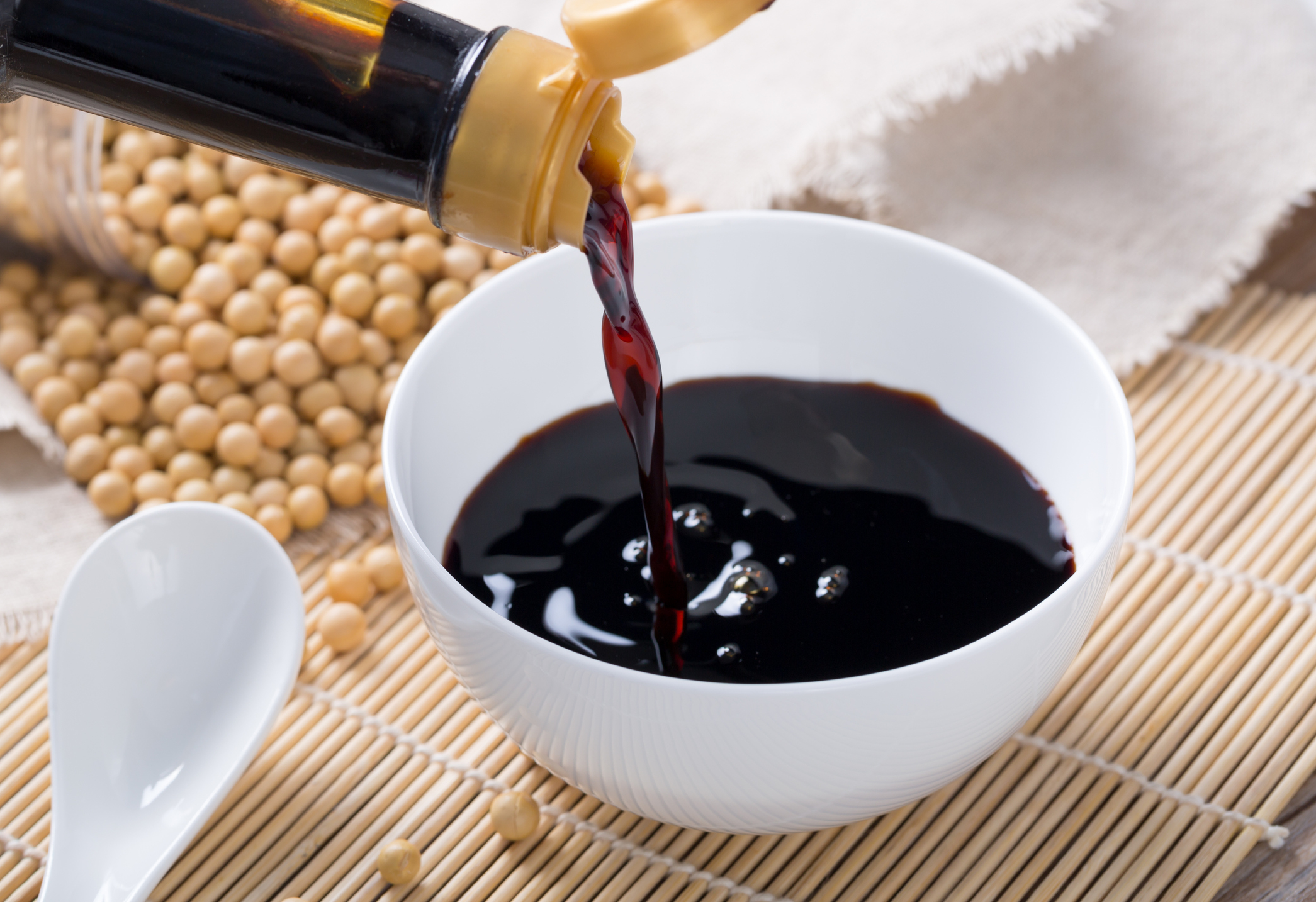 soy sauce being poured into a small bowl