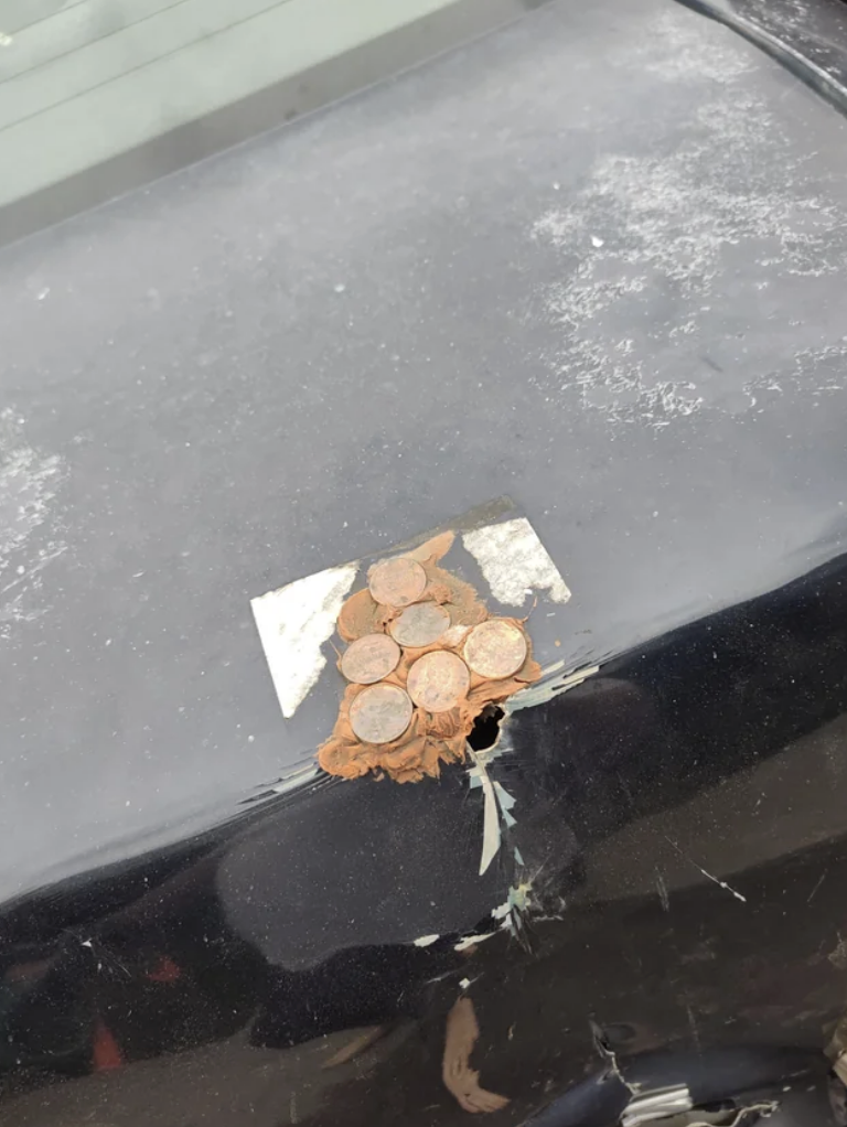 A neighbor repaired a rusty hole in their car with pennies