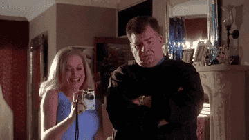Regina George&#x27;s mom excitedly taking a picture and her dad crying