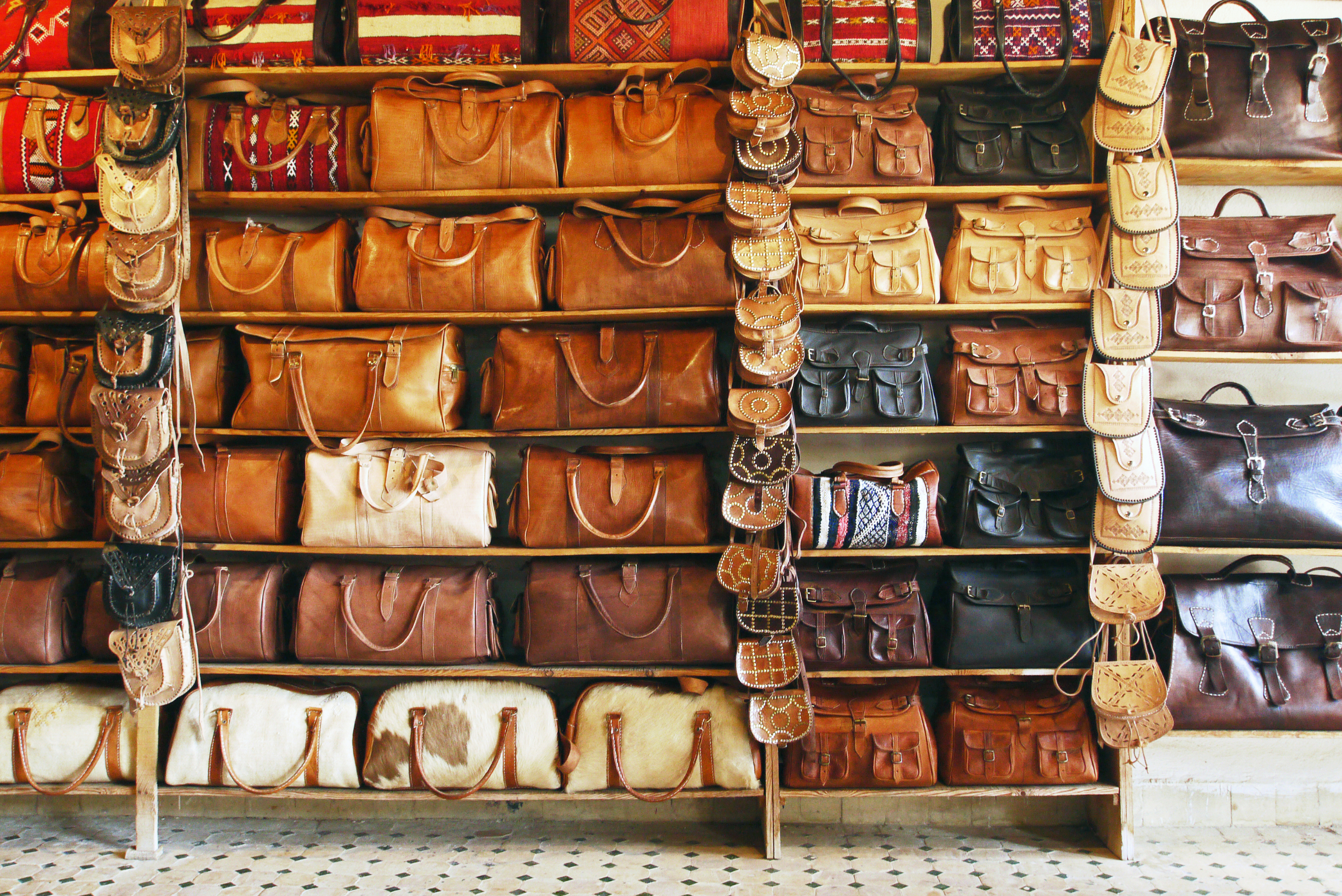 a wall of shelves of Moroccan leather bags
